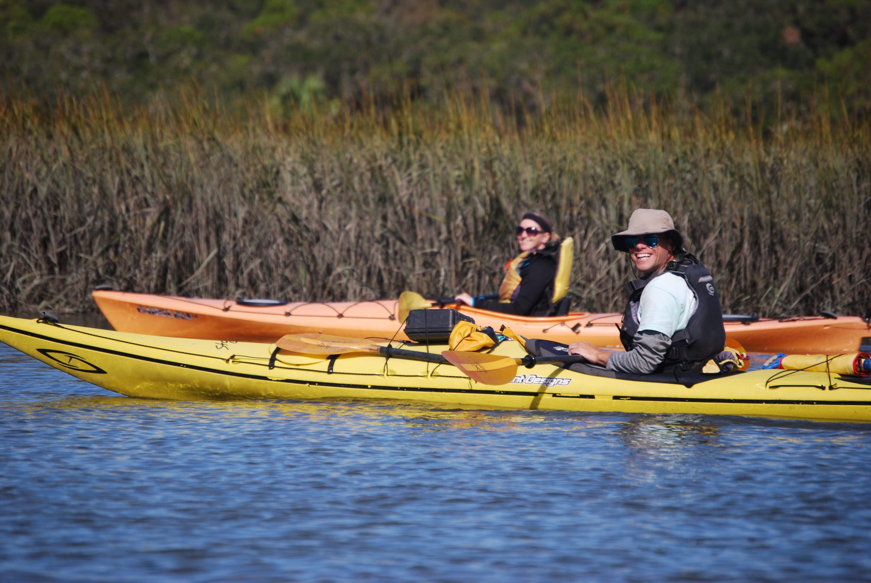 Guide and guest smiling on a kayaking tour.