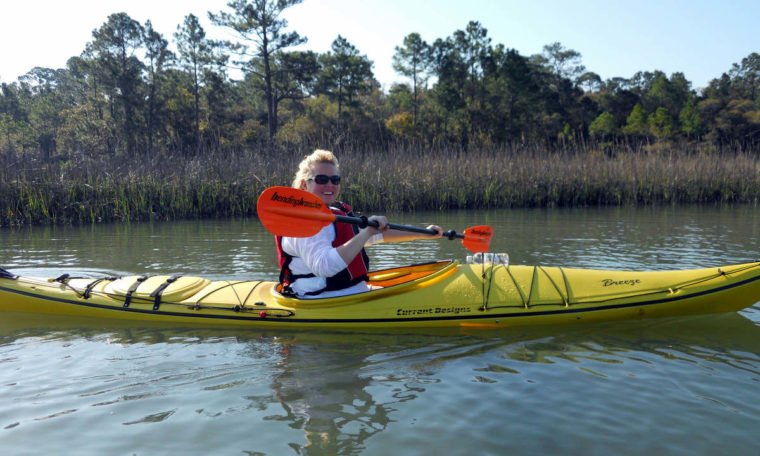 Smiling woman kayaking