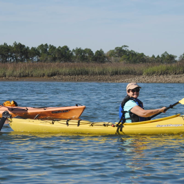 A man and woman enjoy an afternoon kayaking trip.