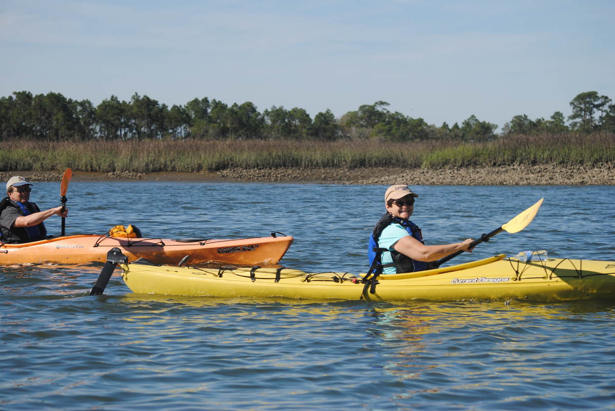 A man and woman enjoy an afternoon kayaking trip.