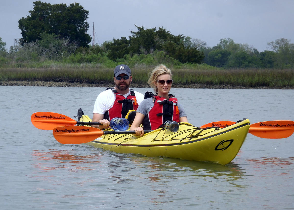 A couple is resting their arms while kayaking in the Lowcountry.
