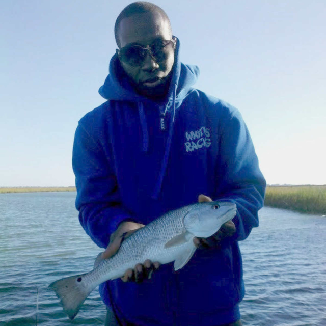 A man caught a spot tailed bass on our inshore fishing charter.