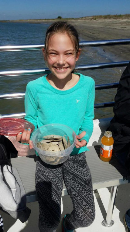 A happy little girl found 20 sand dollars on Morris Island.