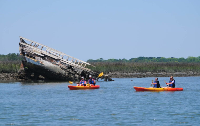 Kayak rentals near a wrecked boat.