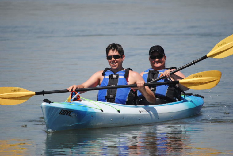 Happy women kayaking on a rental in the spring